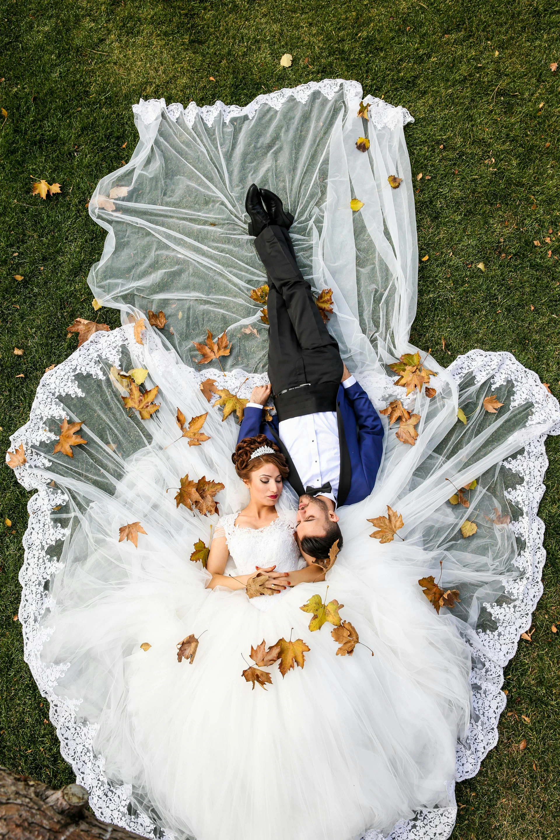 Happy couple lying on grass - wedding planning inspiration